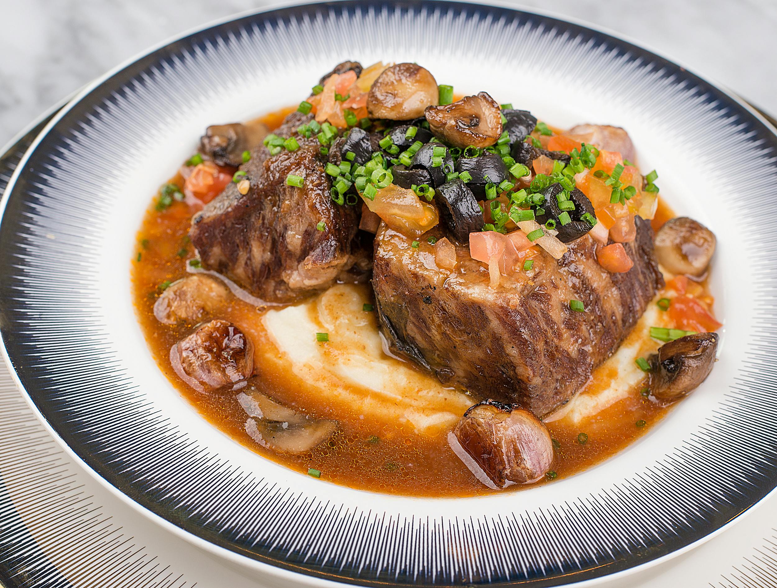 Baised beef meal in a white bowl